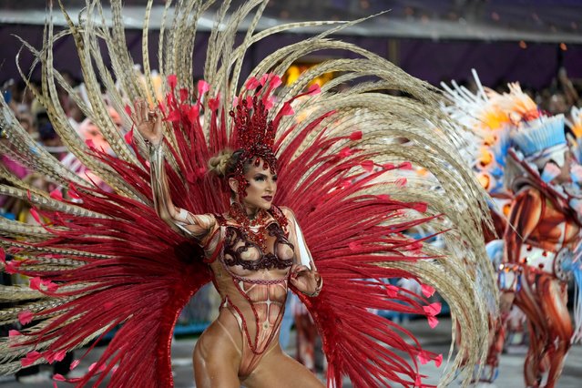 A performer from the Vila Isabel samba school parades during Carnival celebrations at the Sambadrome in Rio de Janeiro, Brazil, early Tuesday, February 13, 2024. (Photo by Silvia Izquierdo/AP Photo)