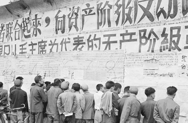In this file photo taken November 1, 1967, Chinese citizens view writings and slogans emblazoned on a wall at the height of the decade-long Cultural Revolution initiated a year earlier by Communist Party Chairman Mao Zedong in Beijing. On May 16, 1966, the Communist Party's Politburo produced a document announcing the start of what was formally known as the Great Proletarian Cultural Revolution to pursue class warfare and enlist the population in mass political movements. Launched by leader Mao Zedong, it set off a decade of tumult to revive communist goals and enforce a radical egalitarianism. (Photo by AP Photo)
