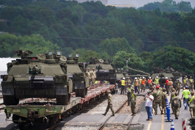 Military personnel and staff work to offload heavy equipment and military vehicles to be used in the U.S. Army's 250th Birthday celebration and Parade in Washington, in Jessup, Maryland, on June 9, 2025. (Photo by Nathan Howard/Reuters)