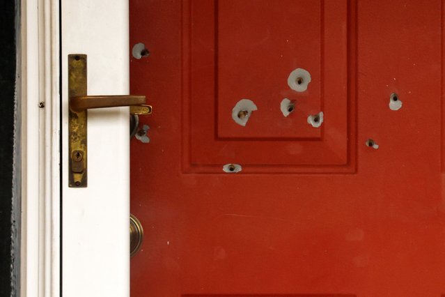 Bullet holes mark the front door of the house of Minnesota state Sen. John Hoffman and his wife who were shot earlier in the day, Saturday, June 14, 2025, in Champlin, Minn. (Photo by Bruce Kluckhohn/AP Photo)