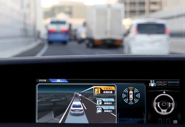 An onboard display monitor shows other vehicles as a staff member of Toyota drives its self-driving technology Mobility Teammate Concept prototype car hands-free on the Metropolitan Expressway in Tokyo, October 2015. (Photo by Yuya Shino/Reuters)