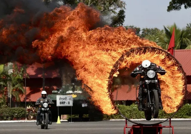 Members of the Indian Army Service Corps (ASC) team known as the “Tornadoes” display their biking skills during the Southern Command Investiture Parade ahead of Indian Army Day at Madras Engineer Group (MEG) in Bangalore, India, 13 January 2023. Bangalore will host the 75th Army Day parade for the first time outside the national capital. The Indian Army Day is celebrated on 15 January annually. (Photo by Jagadeesh N.V./EPA/EFE/Rex Features/Shutterstock)