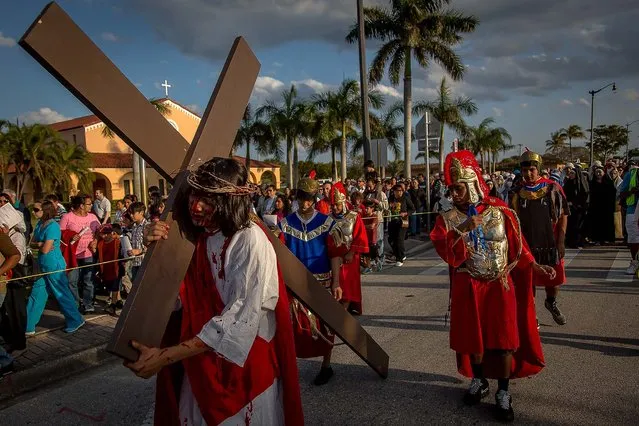 Vega carries the cross as Roman guardsman whip the cross. Hundreds of solemn believers watched and participated in a Passion Play – the dramatic depiction of the Passion of Jesus Christ: his trial, suffering and death – presented on Good Friday by members of St. Juliana Catholic Church in West Palm Beach. (Photo by Thomas Cordy/The Palm Beach Post)