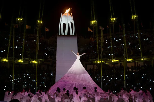 A dancer performs in front of the Paralympic flame during the closing ceremony of the Pyeongchang 2018 Winter Paralympic Games at the Pyeongchang Stadium in Pyeongchang on March 18, 2018. (Photo by Joel Marklund/Reuters/OIS/IOC)