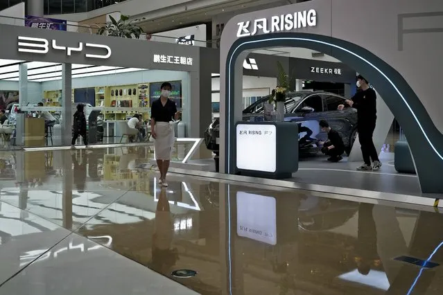 A Rising F7 car model is on display at a floor section selling various Chinese-made electric car brands inside a shopping mall in Beijing, Tuesday, April 4, 2023. Furious at U.S. efforts that cut off access to technology to make advanced computer chips, China's leaders appear to be struggling to figure out how to retaliate without hurting their own ambitions in telecoms, artificial intelligence and other industries. (Photo by Andy Wong/AP Photo)