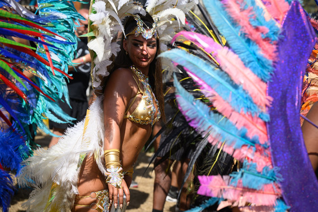 Notting Hill Carnival performers dance with the public at the Carhenge area during day four of Glastonbury Festival 2024 at Worthy Farm, Pilton on June 29, 2024 in Glastonbury, England. Founded by Michael Eavis in 1970, Glastonbury Festival features around 3,000 performances across over 80 stages. Renowned for its vibrant atmosphere and iconic Pyramid Stage, the festival offers a diverse lineup of music and arts, embodying a spirit of community, creativity, and environmental consciousness. (Photo by Leon Neal/Getty Images)