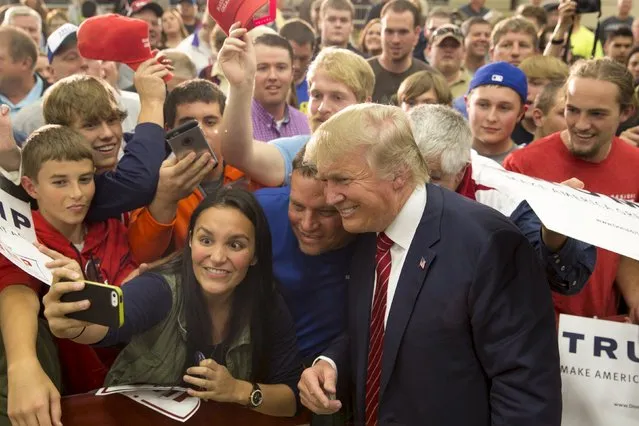 Republican U.S. presidential candidate Donald Trump poses for a photo with supporters after speaking at a campaign rally at West High School in Sioux City, Iowa, October 27, 2015. (Photo by Scott Morgan/Reuters)