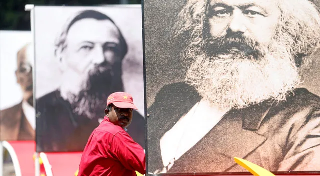 A man looks on next to an image of Karl Marx during a May Day rally organized by Front Line Socialist Party in Colombo, Sri Lanka May 1, 2018. (Photo by Dinuka Liyanawatte/Reuters)