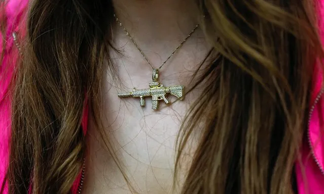 A person wears a necklace of an AR15 rifle during the National Rifle Association (NRA) annual convention in Indianapolis, Indiana, U.S., April 15, 2023. (Photo by Evelyn Hockstein/Reuters)