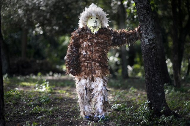Mechanic Victor Gonzalez poses for a photo in his feathered costume, prior to attending a church service to pay tribute to Saint Francisco Solano, in Emboscada, Paraguay, July 24, 2024. (Photo by Jorge Saenz/AP Photo)