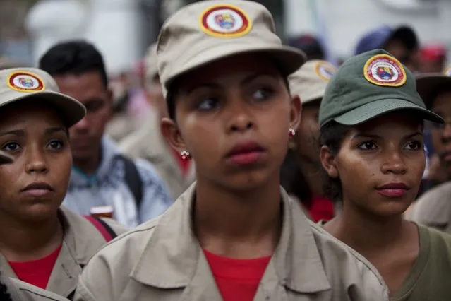 Women members of the Bolivariana militia gather during a march to support Venezuela's President Nicolas Maduro, outside Miraflores presidential palace in Caracas, Venezuela, Thursday, October 27, 2016. Electoral authorities blocked a recall campaign against Maduro last week, and a face-off with congress escalated on Tuesday when the legislature voted to put Maduro on trial, accusing him of effectively staging a coup. (Photo by Rodrigo Abd/AP Photo)
