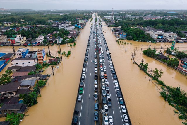 Image taken with a drone) Authorities in Ang Thong Province enforce a temporary road closure on Highway 33 (Route 33), the Pa MokSuphan Buri section, in Ekkarat Subdistrict, Pa Mok District. The closure is necessitated by severe flooding, with high-standing water covering a stretch of approximately 500 meters, making the route impassable for small vehicles. (Photo by Arnun Chonmahatrakool/Thai News Pix/LightRocket via Getty Images)