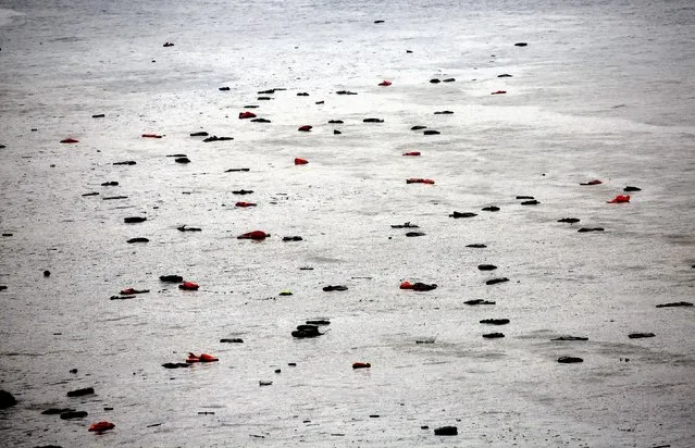Life jackets and tubes left by migrants float by a beach during a rainstorm on the Greek island of Lesbos October 21, 2015. (Photo by Yannis Behrakis/Reuters)