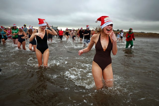 Revellers take part in a boxing day dip on December 26, 2024 in Ayr, Scotland. The event is a charity swim that raises funds for Ayrshire Cancer Support, which provides free services to people in Ayrshire affected by cancer. (Photo by Jeff J. Mitchell/Getty Images)