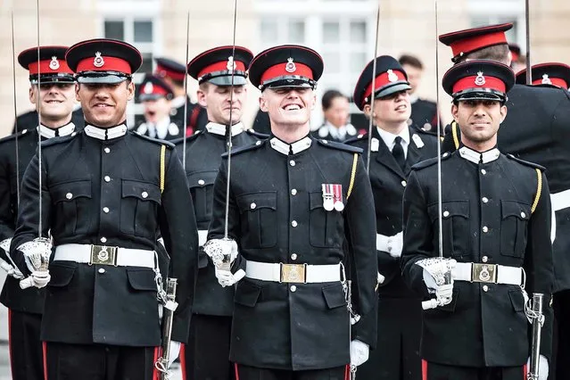 Graduating officer cadets of the Royal military academy in Sandhurst relax as they wait to take part in the Sovereign's parade on August 10, 2018. The Parade marks the completion of a year’s intensive training for 190 officer cadets from the United Kingdom and 30 officer cadets from 17 overseas countries. The United Kingdom officer cadets will be officially commissioned as officers in the British Army at midnight on the 10th August and those from overseas will return to their countries’ armies. Also on Parade will be the officer cadets from the junior and intermediate terms. (Photo by Richard Pohle/The Times Newspapers)