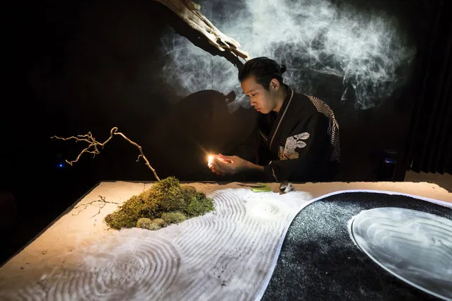 A guide wearing a kimono lights incense in the waiting room of the Tree by Naked, Yoyogi Park restaurant  produced by Naked Inc. on August 16, 2018 in Tokyo, Japan. The latest technologies are utilized in the restaurant offering art gastronomy experiences combining a dinner course, projection mapping, virtual reality, sensing, lighting, smoke, fragrance and music to attract their guests. The restaurant allows only 8 pairs of guests a night and aims to be a new destination for tourists in Japan, with a record 28.7 million people visiting the country in 2017. (Photo by Tomohiro Ohsumi/Getty Images)