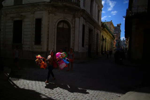 A woman carries balloons as she walks along a street in Old Havana, following the announcement of the death of Cuban revolutionary leader, in Cuba November 27, 2016. (Photo by Carlos Barria/Reuters)