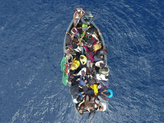 An aerial photo shows a boat carrying migrants stranded in the Strait of Gibraltar before being rescued by the Spanish Guardia Civil and the Salvamento Maritimo sea search and rescue agency that saw 157 migrants rescued on September 8, 2018. While the overall number of migrants reaching Europe by sea is down from a peak in 2015, Spain has seen a steady increase in arrivals this year and has overtaken Italy as the preferred destination for people desperate to reach the continent. Over 33,000 migrants have arrived in Spain by sea and land so far this year, and 329 have died in the attempt, according to the International Organization for Migration. (Photo by Marcos Moreno/AFP Photo)
