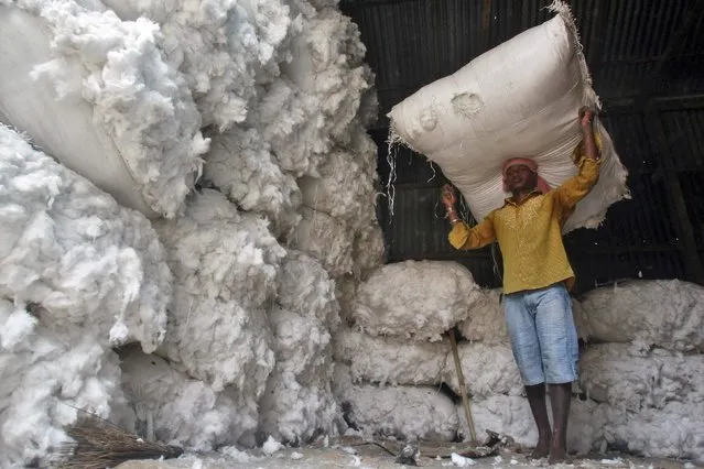 A worker carries a sack filled with cotton at a wholesale cotton market in Agartala, capital of India's northeastern state of Tripura, in this April 16, 2014 file photo. (Photo by Jayanta Dey/Reuters)