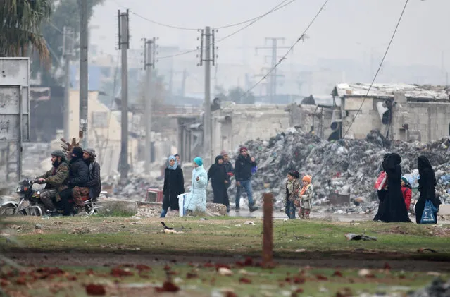 Civilians carry their belongings as they flee deeper into the remaining rebel-held areas of Aleppo, Syria December 7, 2016. (Photo by Abdalrhman Ismail/Reuters)