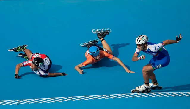 Vincenzo Maiorca of Italy takes the lead as Chiawei Chang of Taiwan and Merijn Scheperkamp of the Netherlands fall during the Roller Speed Skating Mens Combined Speed Event Final at the Paseo De La Costa during the Youth Olympic Games, Buenos Aires, Argentina October 8, 2018. (Photo by Simon Bruty for OIS/IOC/Handout via Reuters)