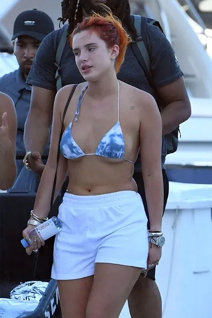 Actress Bella Thorne wears a blue and white bikini as she holds hands with fiancé Benjamin Mascolo while getting off a yacht in Miami on May 5, 2021. (Photo by The Mega Agency)