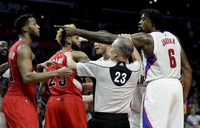 Referee Jason Phillips (23) breaks up a altercation between LA Clippers center DeAndre Jordan, right, and Portland Trail Blazers guard Evan Turner during the second half of an NBA basketball game in Los Angeles, Monday, December 12, 2016. The Clippers won 121-120. (Photo by Chris Carlson/AP Photo)