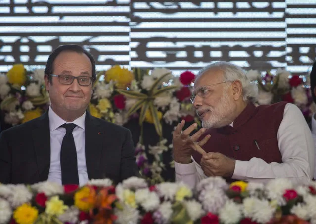 French President Francois Hollande, left, and Indian Prime Minister Narendra Modi interact during the foundation stone laying for the headquarters of the International Solar Alliance at Gurgaon, outskirts of New Delhi, India, Monday, January 25, 2016. The solar energy alliance was launched last month during global climate talks held in Paris. Hollande is on a three-day visit to India. (Photo by Saurabh Das/AP Photo)