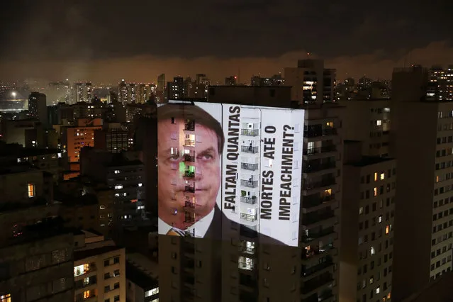 An image of Brazil's President Jair Bolsonaro with the phrase “How many deaths until impeachment” is projected on a building during a protest against his policies for the coronavirus disease (COVID-19) outbreak and Manaus' health crisis at Santa Cecilia neighbourhood in Sao Paulo, Brazil on January 15, 2021. (Photo by Amanda Perobelli/Reuters)
