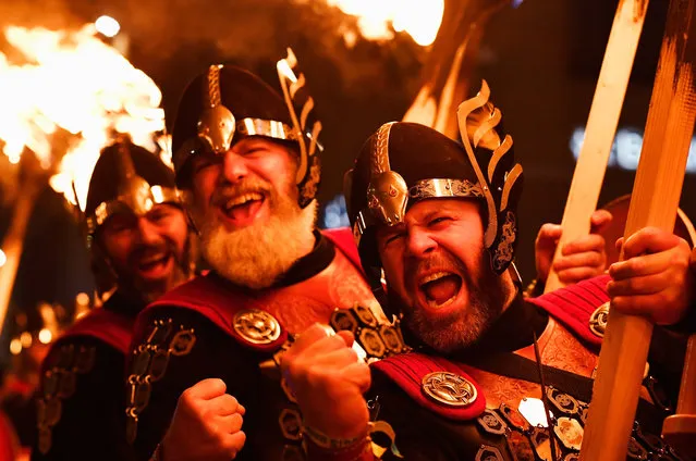 Up Helly Aa Vikings take part during a torchlight procession through Edinburgh for the start of the Hogmanay celebrations on December 30, 2016 in Edinburgh, Scotland. It is expected to bring in 150,000 visitors from more than 80 countries to the city for the traditional New Year celebrations, which run over three days. (Photo by Jeff J. Mitchell/Getty Images)