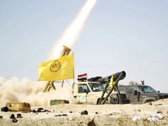 Shi'ite paramilitary fighters launch a rocket towards Islamic State militants in Tikrit March 31, 2015. (Photo by Alaa Al-Marjani/Reuters)