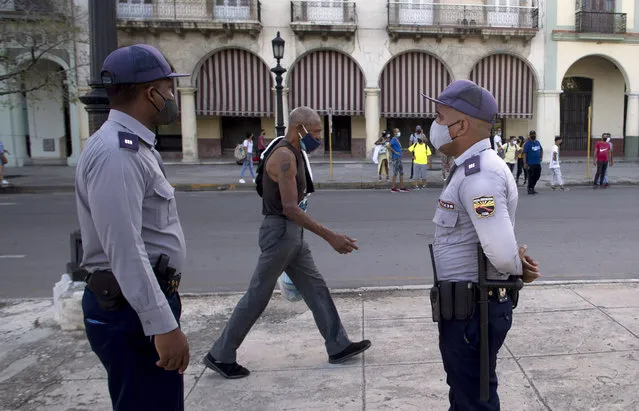 Police stand guard near the National Capitol building in Havana, Cuba, Monday, July 12, 2021, the day after protests against food shortages and high prices amid the coronavirus crisis. (Photo by Ismael Francisco/AP Photo)