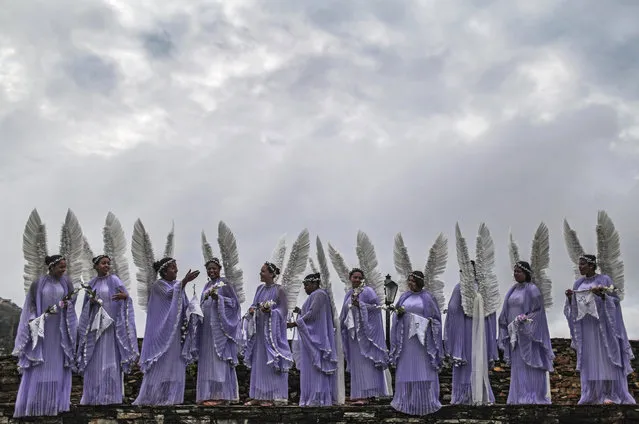 Women dressed as angels gather to pose for a group photo before the annual Easter procession during traditional Semana Santa (Holy Week) festivities on April 5, 2015 in Ouro Preto, Brazil. (Photo by Mario Tama/Getty Images)