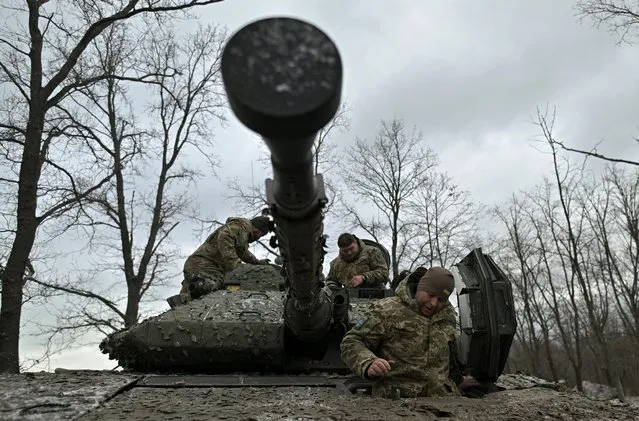 Ukrainian servicemen check their Sweden made CV90 armored infantry combat vehicle on a position pointing in the direction of Bakhmut in the Donetsk region on November 27, 2023, amid the Russian invasion of Ukraine. (Photo by Genya Savilov/AFP Photo)