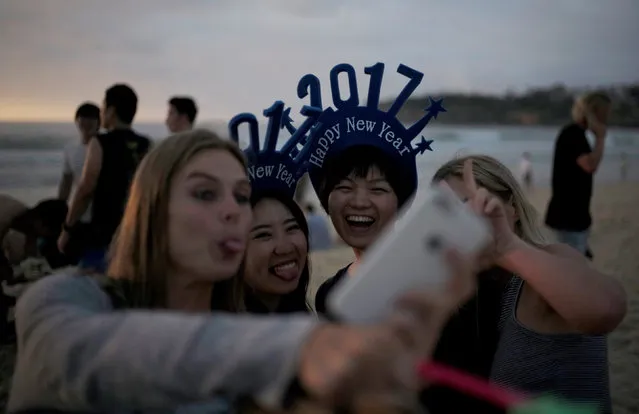Visitors to Sydney's Bondi Beach take a selfie as they welcome the first sunrise of 2017 following new year celebrations in Australia's largest city, January 1, 2017. (Photo by Jason Reed/Reuters)