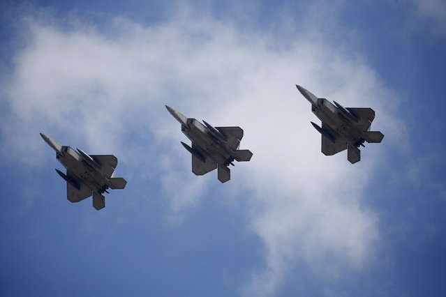 U.S. F-22 stealth fighter jets fly over Osan Air Base in Pyeongtaek, South Korea, February 17, 2016. (Photo by Kim Hong-Ji/Reuters)