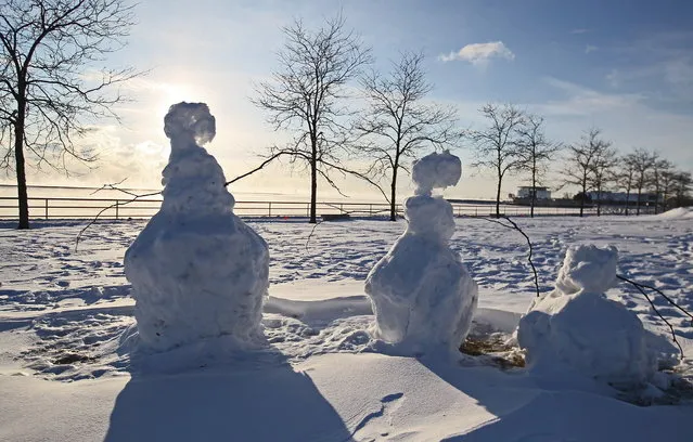 January 6, 2014  Photographs of the cold in and around Milwaukee.  Here a snowman family seemed to be one of the few to stand their ground against the cold along Milwaukee's lakefront. (Photo by Michael Sears/Milwaukee Journal Sentinel)