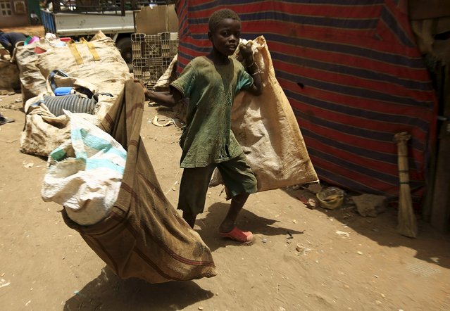 A boy carries empty sacks after bringing different types of plastic materials to a recycling station in Khartoum North April 16, 2015. People bring bottles and other plastic materials to the station for recycling, and get paid in return. (Photo by Mohamed Nureldin Abdallah/Reuters)