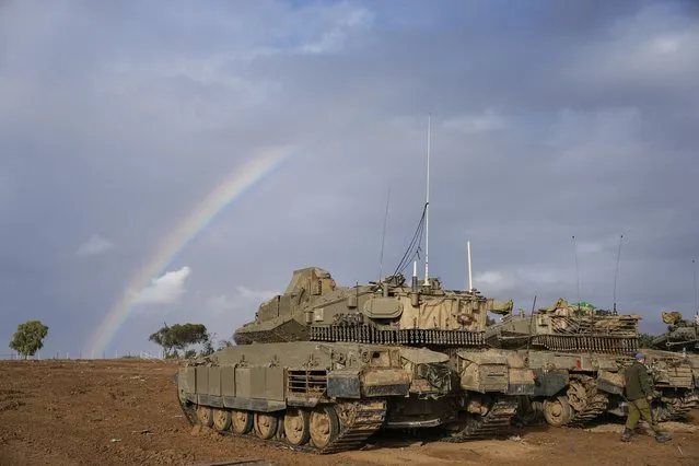 Israeli tanks are parked at an army staging area near Israel's border with Gaza, southern Israel, Monday, November 27, 2023. on the fourth day of a temporary cease-fire between Israel and Hamas. (Photo by Ohad Zwigenberg/AP Photo)