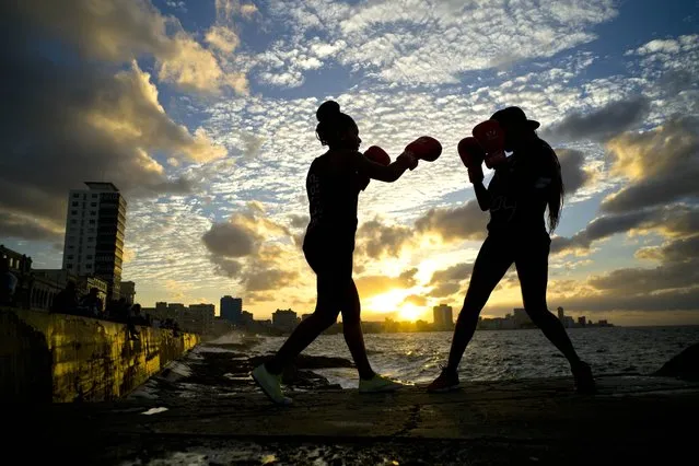 In this January 30, 2017 photo, boxers Idamerys Moreno, left, and Legnis Cala, train during a photo session on Havana's sea wall, in Cuba. Moreno and Cala are part of a group of up-and-coming female boxers on the island who want government support to form Cuba's first female boxing team and help dispel a decades-old belief once summed up by a former top coach: “Cuban women are meant to show the beauty of their face, not receive punches”. (Photo by Ramon Espinosa/AP Photo)