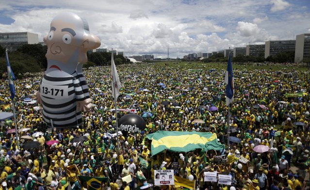 An inflatable doll known as “Pixuleco” of Brazil's former President Luiz Inacio Lula da Silva  is seen during a protest against Brazil's President Dilma Rousseff, part of nationwide protests calling for her impeachment, near the Brazilian national congress in Brasilia, Brazil, March 13, 2016. (Photo by Ueslei Marcelino/Reuters)