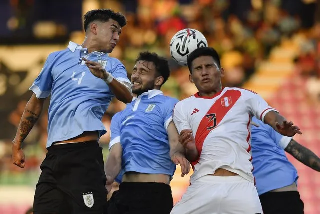 Uruguay's Mateo Ponte, left, heads the ball challenged by Peru's Alejandro Posito during South America's under-23 pre-Olympic tournament soccer match at the Misael Delgado stadium in Valencia, Venezuela, Tuesday, January 30, 2024. (Photo by Matias Delacroix/AP Photo)