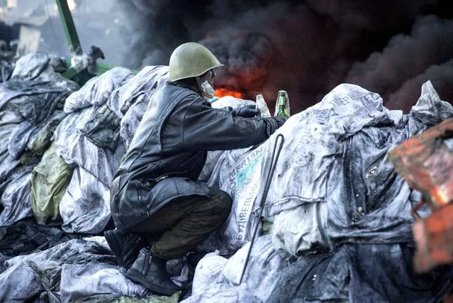 Anti-government protesters clash with riot police in Kiev's Independence Square, the epicenter of the country's current unrest. (Photo by Francesca Volpi/SIPA Press)