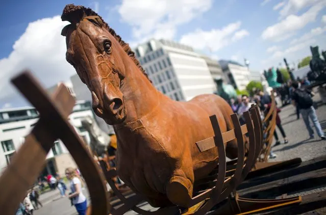 One of 20 horses in the travelling art exhibition called “Lapidarium” by Mexican artist Gustavo Aceves, is seen near Brandenburg Gate in Berlin, Germany, May 4, 2015. (Photo by Hannibal Hanschke/Reuters)