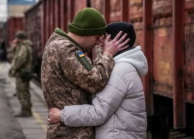 Ukrainian serviceman says goodbye to his wife who was visiting him during a short break from his frontline duty, at the train station in Kramatorsk, Ukraine, on February 14, 2024. (Photo by Inna Varenytsia/Reuters)