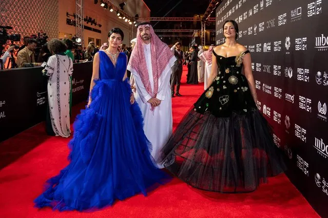 A handout picture released by the Red Sea Film Festival shows Saudi actress Mila Al Zahrani and Saudi producer and Chairman of the Festival Mohammed Al Turki and actress Fay Fouad on the red carpet during the opening ceremony of the 4th edition of the Red Sea film festival in the Saudi city of Jeddah, on December 6, 2021. (Photo by Ammar Abd Rabbo/Red Sea Film Festival/AFP Photo)