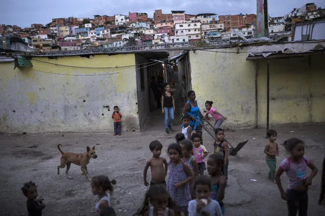 Children play at Los Hijos de Dios settlement, once an empty field owned by the government and now occupied by about 60 families, in Caracas, Venezuela, Wednesday, May 8, 2019. More than 3 million Venezuelans have left their homeland in recent years amid skyrocketing inflation and shortages of food and medicine. U.S. administration officials have warned that 2 million more are expected to flee by the end of the year if the crisis continues in the oil-rich nation. (Photo by Rodrigo Abd/AP Photo)