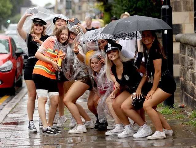 The miserable weather hasn't stopped these girls dressing up for a big night out in Leeds in the northern English county of Yorkshire on August 7, 2021. (Photo by Nb press ltd)