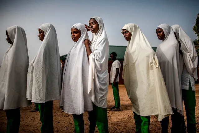A group of Fulani students queue at the school grounds before the beginning of the day's lessons at Wuro Fulbe Nomadic School in Kacha Grazing Reserve for Fulani people, Kaduna State, Nigeria, on April 19, 2019. (Photo by Luis Tato/AFP Photo)