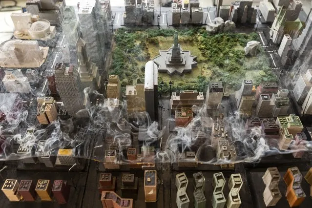 Electric lines glow red and smoke in a tabletop diorama of Manhattan during a simulation at the Red Balloon Security Inc. office in New York, U.S., on Thursday, January 6, 2022. Red Balloon recently built the miniature city in an effort to recreate how hacks might impact the electrical grid. (Photo by Angus Mordant/Bloomberg)